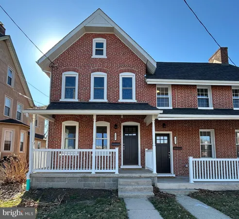 a front view of a house with a fence