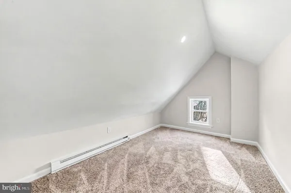an empty room with a white walls and a window