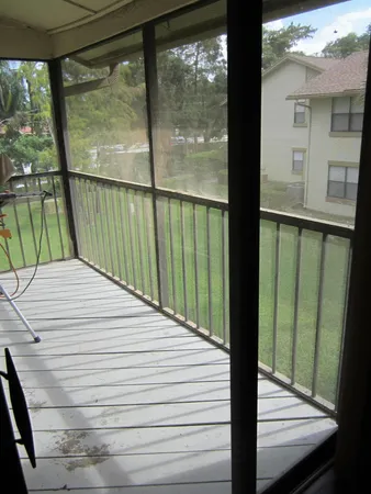 a view of a balcony with a floor to ceiling window