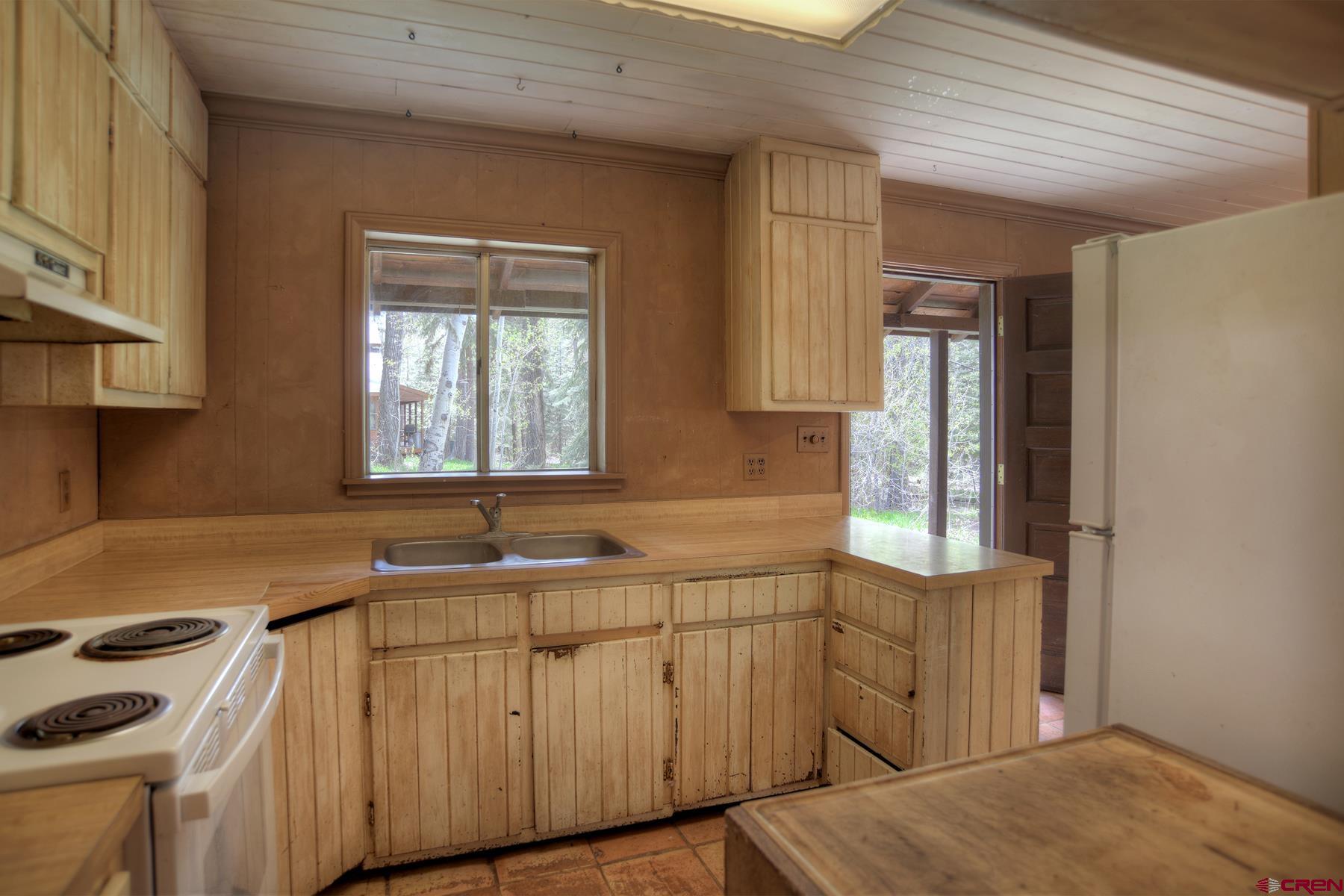 207 Verde Lane Durango, CO 81301 - Photo 19 of 45 a kitchen with a sink stove and cabinets