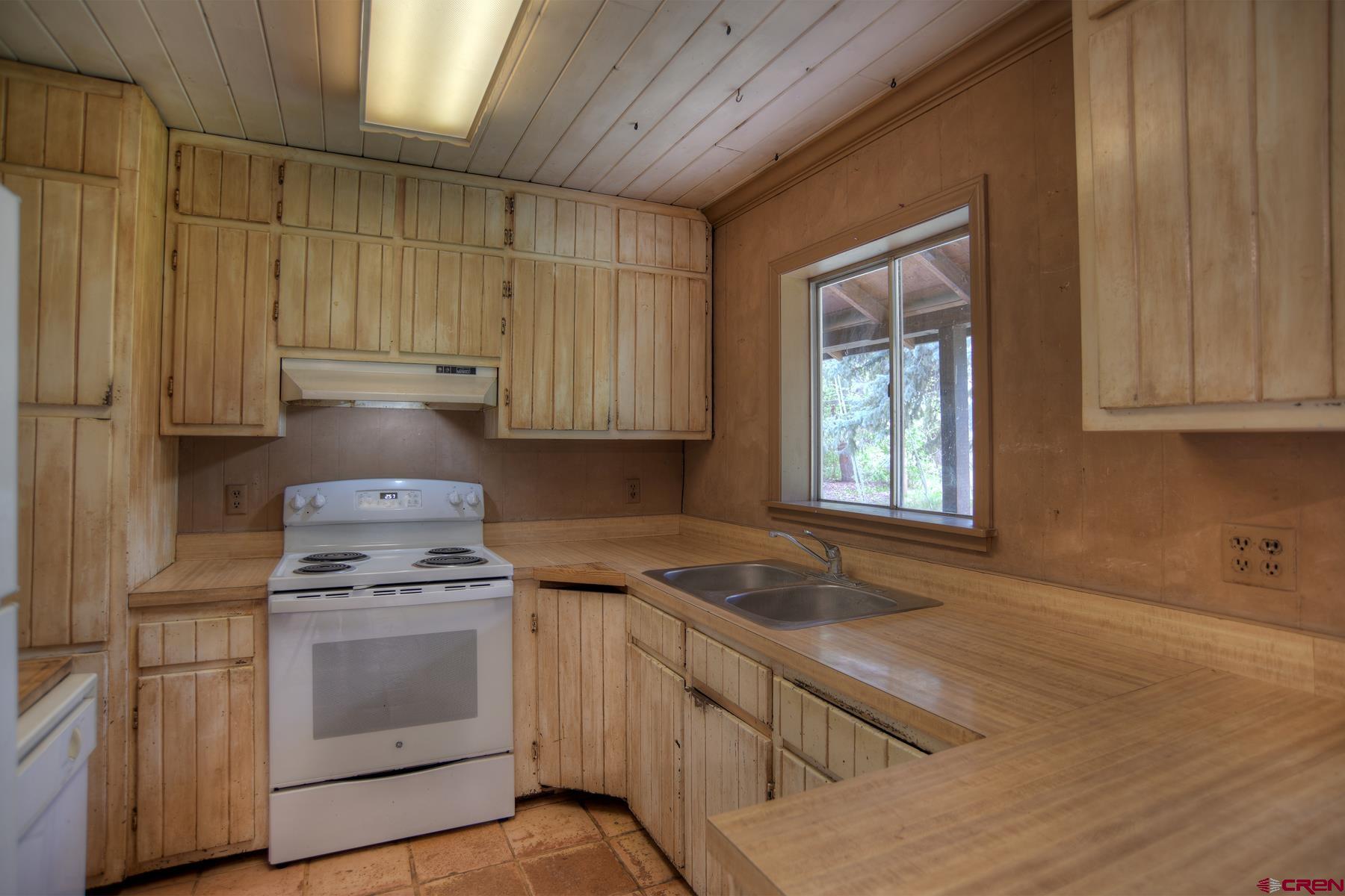 207 Verde Lane Durango, CO 81301 - Photo 20 of 45 a kitchen with granite countertop white cabinets and white appliances