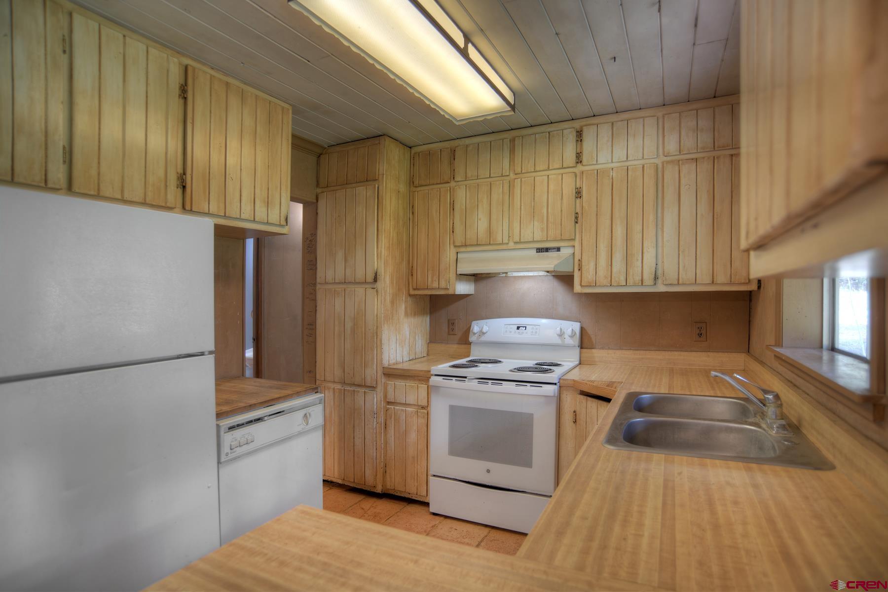 207 Verde Lane Durango, CO 81301 - Photo 21 of 45 a kitchen with a stove a refrigerator and a sink