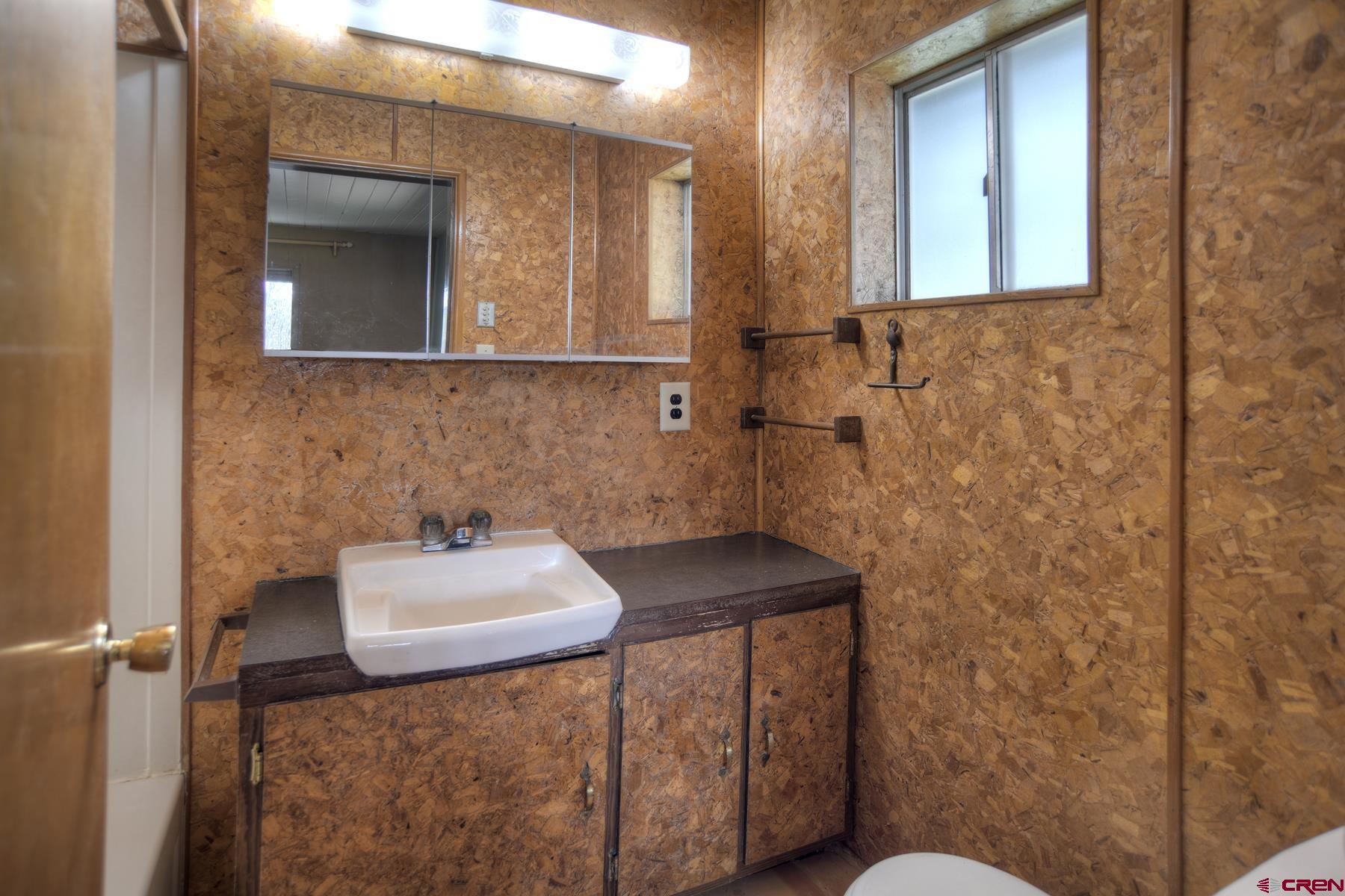 207 Verde Lane Durango, CO 81301 - Photo 26 of 45 a bathroom with a sink toilet and mirror