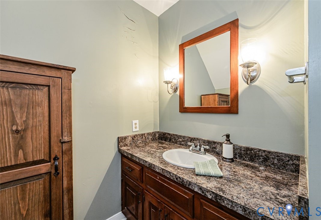 7300 Old Roxbury Road Quinton, VA 23141 - Photo 64 of 89 Built-in wood cabinetry with dark hardware, a vani