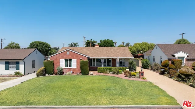a front view of a house with a garden and porch