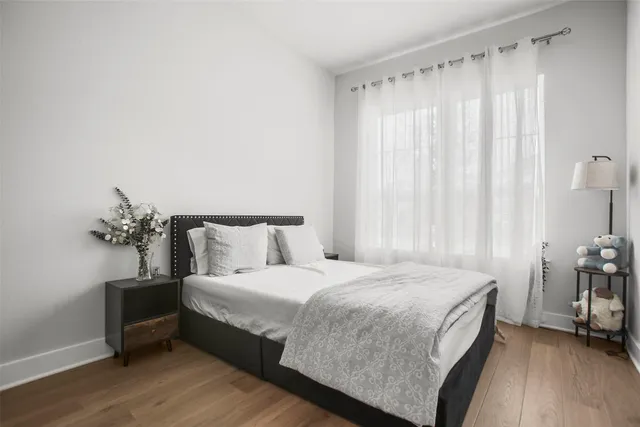 a bedroom with a bed and a mirror