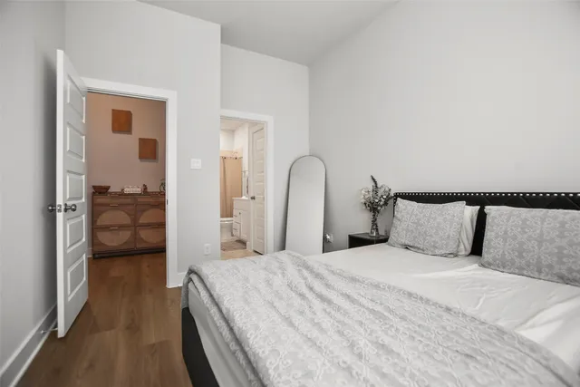 a bedroom with a bed and a large mirror