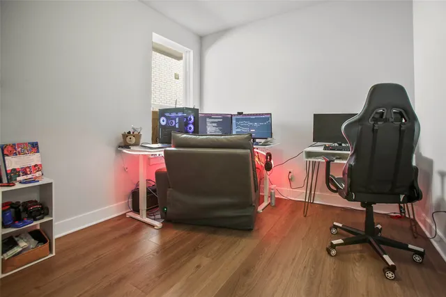 a view of a workspace with furniture and a window