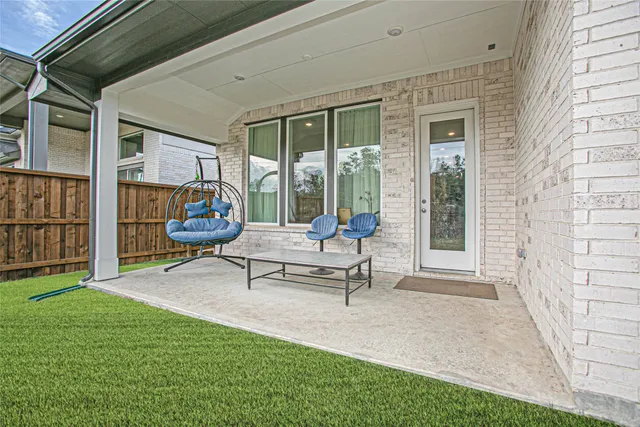 a swimming pool with outdoor seating and a garden