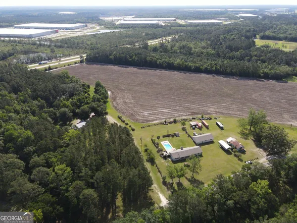an aerial view of a house with a yard