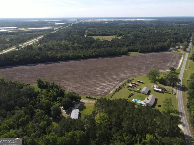 an aerial view of a house with a yard