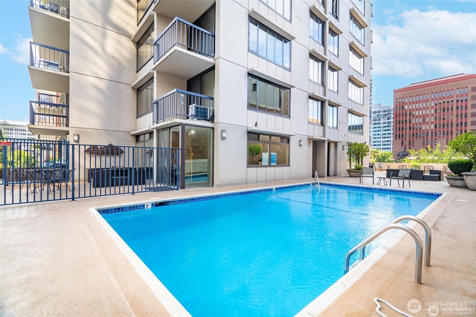 2100 3rd Avenue, Unit 802 Seattle, WA 98121 - Photo 29 of 35 a view of a swimming pool with a lounge chairs