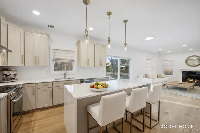 a kitchen with a dining table chairs sink and cabinets
