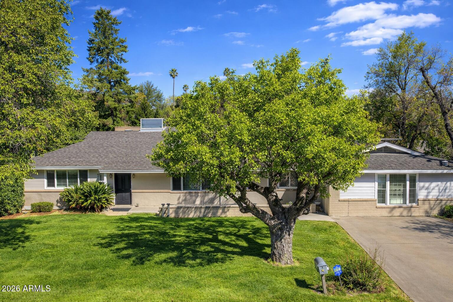 1532 West Loma Lane Phoenix, AZ 85021 - Photo 1 of 19 a front view of a house with a garden