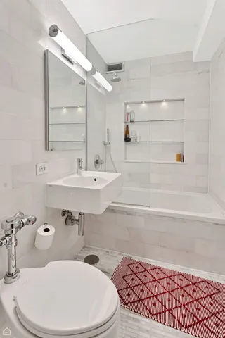 a bedroom with a bed window and a flat screen tv