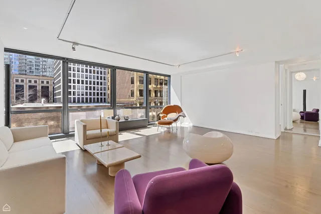 a living room with furniture and kitchen view