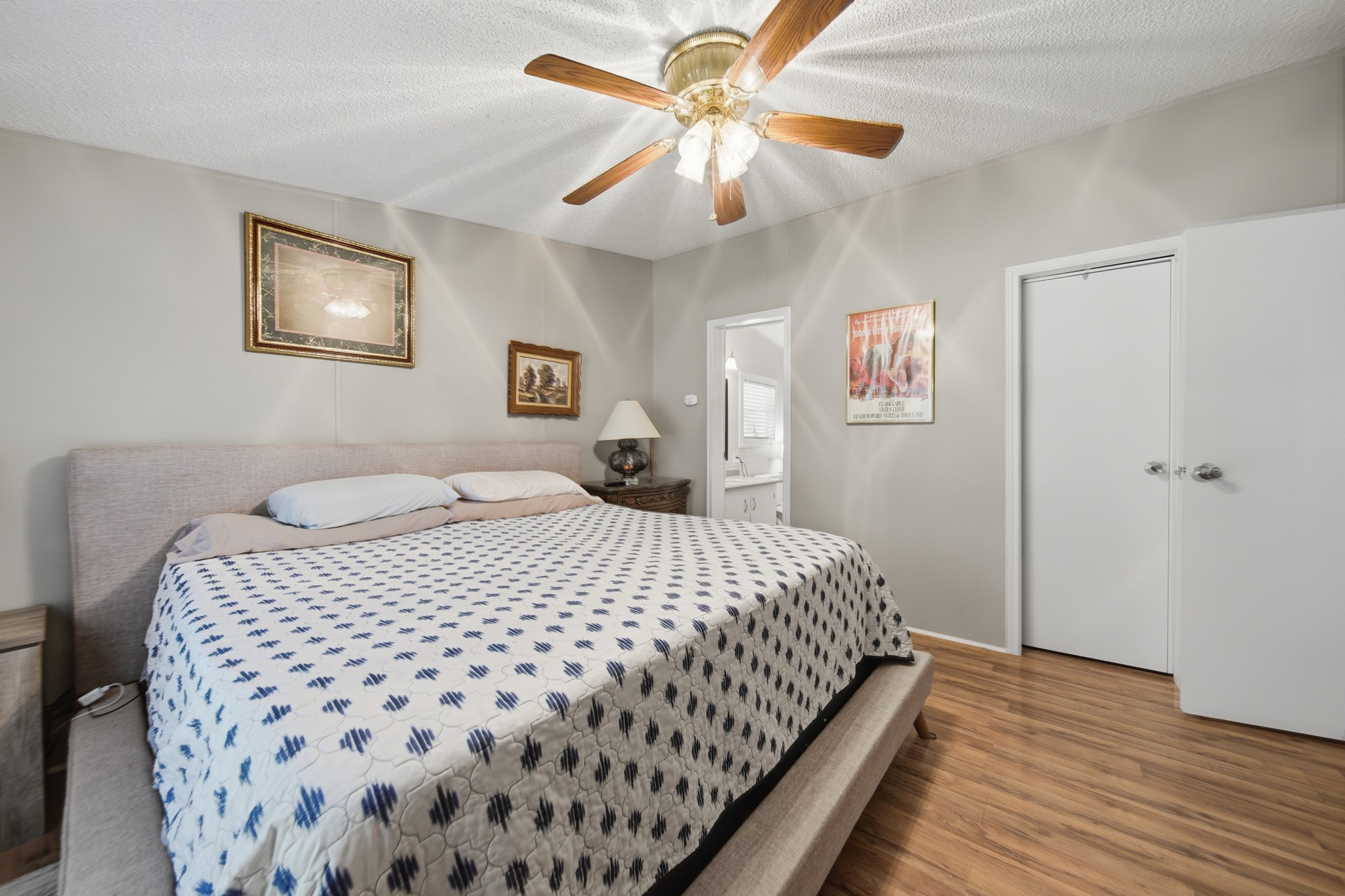 199 Apple Tree Livingston, TX 77351 - Photo 26 of 41 a bedroom with a bed and a chandelier