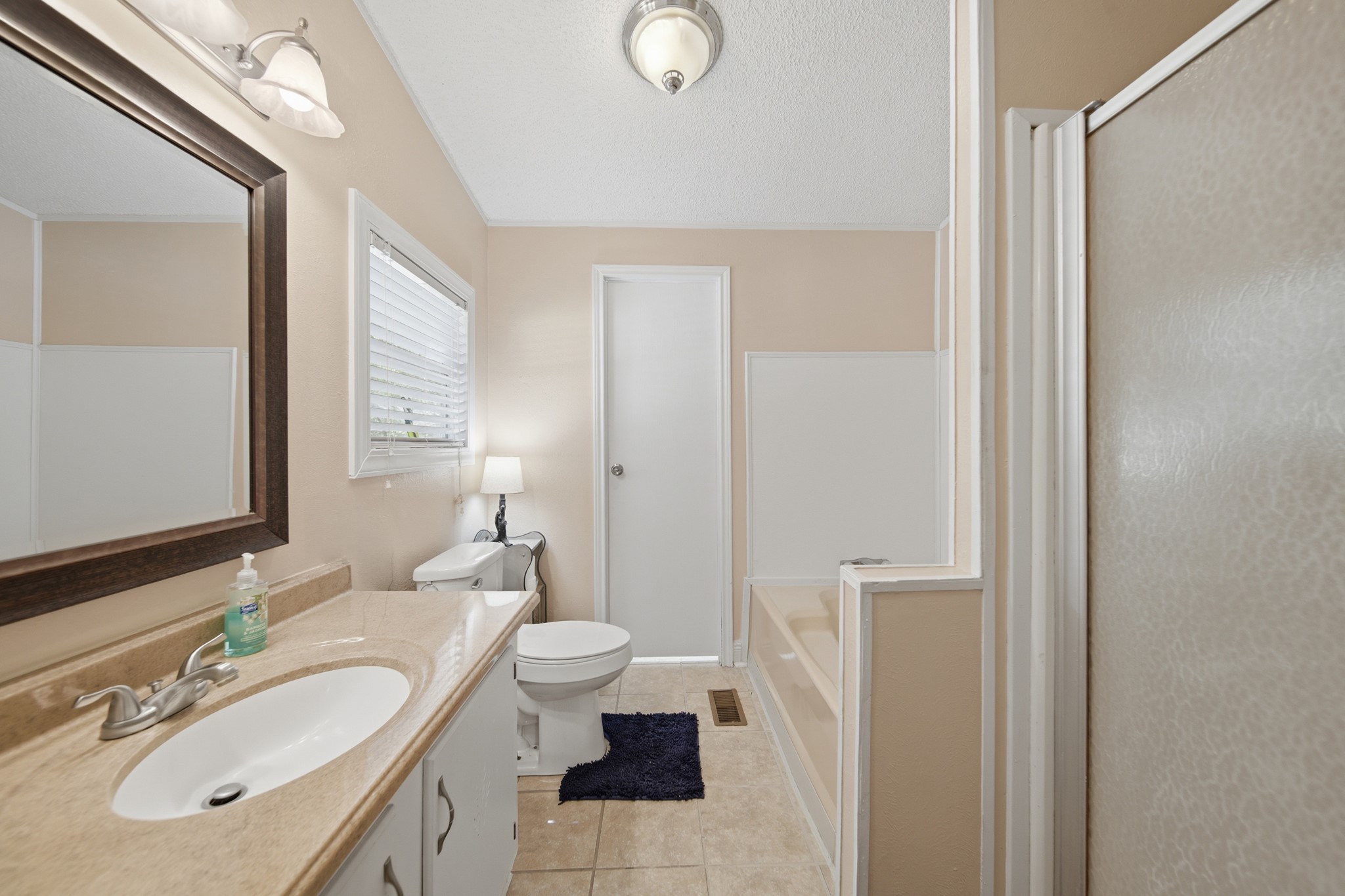 199 Apple Tree Livingston, TX 77351 - Photo 27 of 41 a bathroom with a granite countertop sink toilet and shower