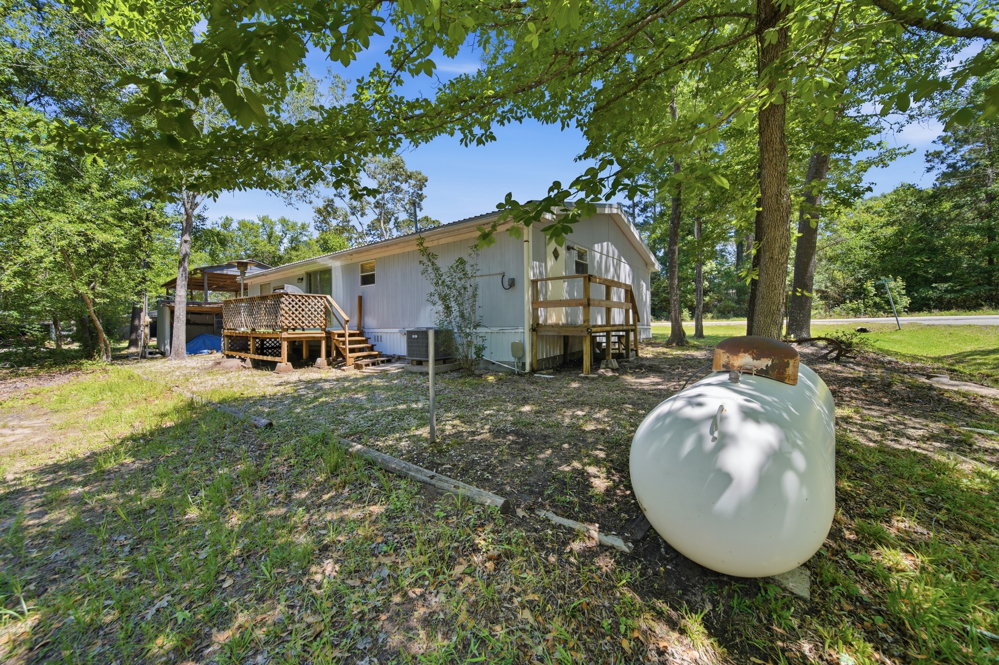 199 Apple Tree Livingston, TX 77351 - Photo 34 of 41 Back of the house with propane tank- Owned, not leased.