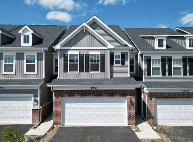a front view of a house with a garage
