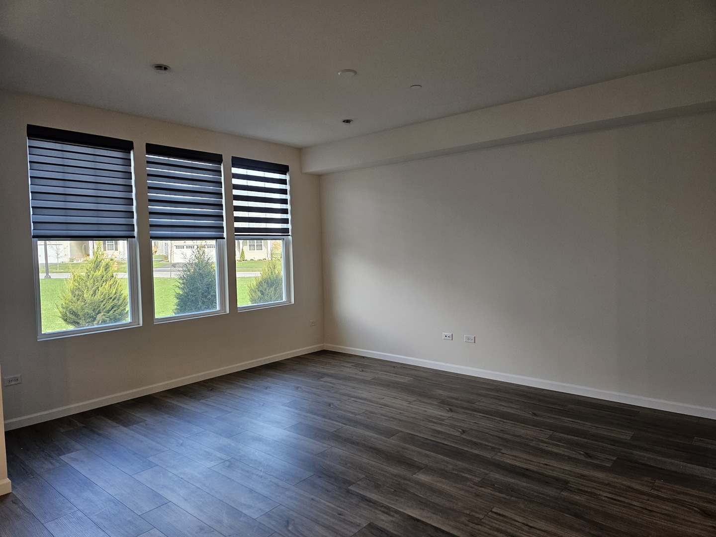 5954 Hawkweed Drive, Unit 5954 Plainfield, IL 60585 - Photo 12 of 35 a view of an empty room with wooden floor and a window