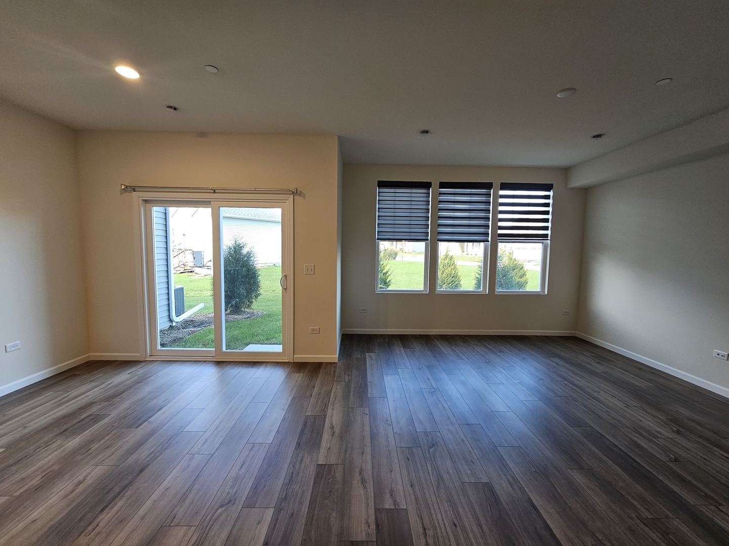 5954 Hawkweed Drive, Unit 5954 Plainfield, IL 60585 - Photo 13 of 35 an empty room with wooden floor and windows