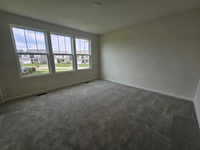 an empty room with a empty space and windows