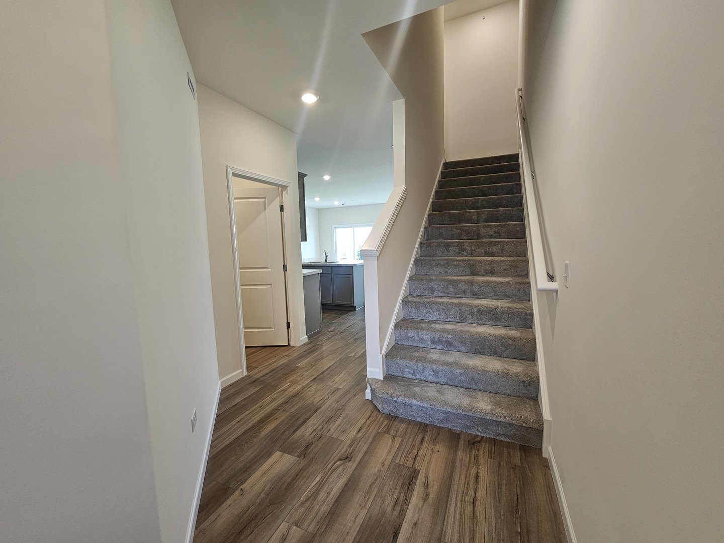 5954 Hawkweed Drive, Unit 5954 Plainfield, IL 60585 - Photo 14 of 35 a view of a hallway with wooden floor and entryway