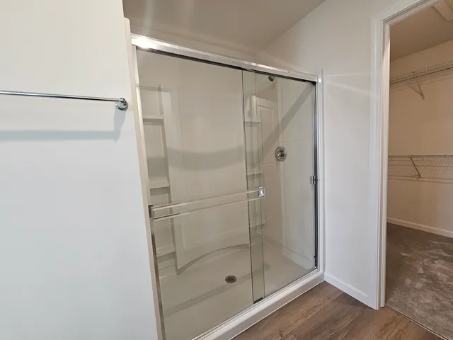 a bathroom with a glass shower door