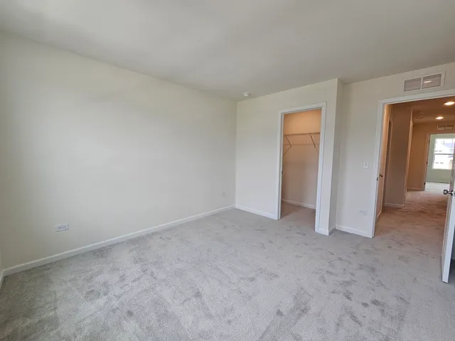 a view of an empty room and closet area