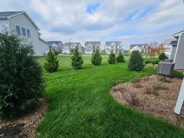 a view of a garden with a building in the background