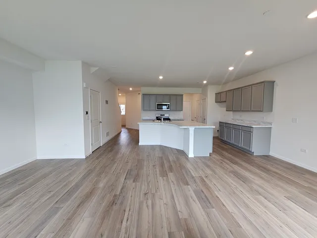 a view of kitchen with wooden floor and electronic appliances