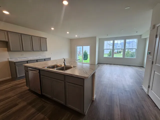 an open kitchen with sink and cabinets