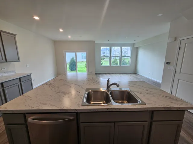 a kitchen with a sink a counter space and a window