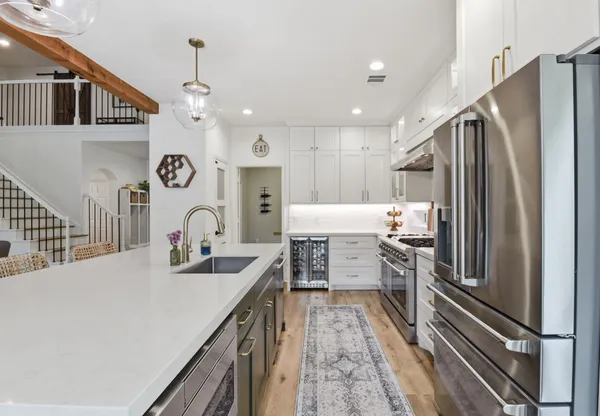 a kitchen with a refrigerator and a sink