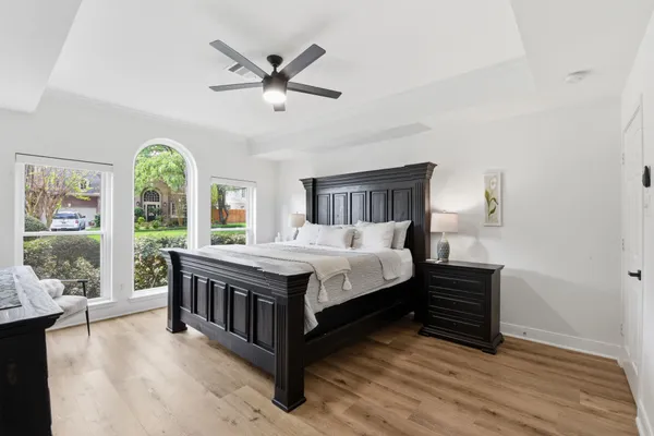a spacious bedroom with a bed and a large window