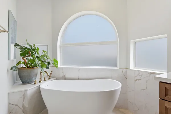 a white bath tub sitting in a bathroom