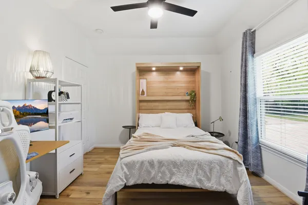 a bedroom with a bed and a chandelier