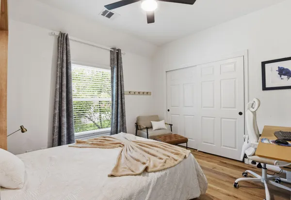 a bedroom with a bed and a window