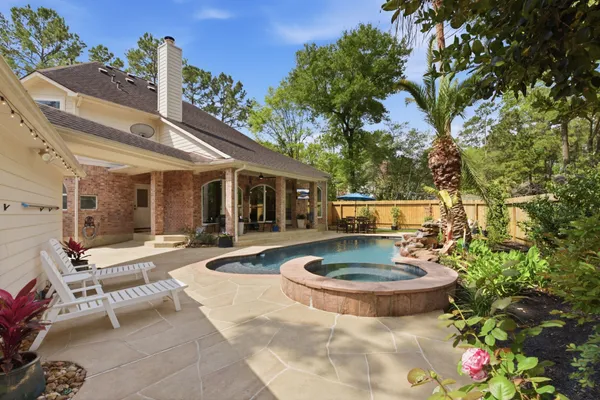 a view of a house with backyard and sitting area