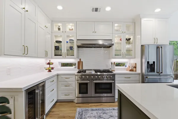 a kitchen with stainless steel appliances granite countertop a stove and a refrigerator