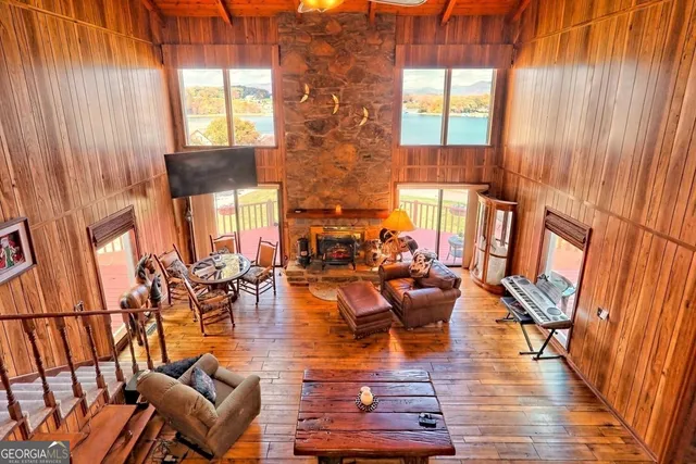a living room with fireplace furniture and a large window