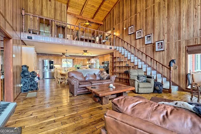 a living room with lots of furniture and wooden floor