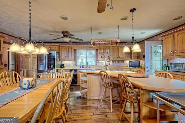 a dining area with furniture and chandelier