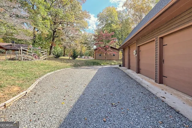 a view of a yard with a house and trees beside of it