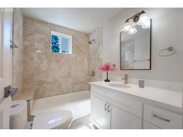 a bathroom with a bathtub a sink and a mirror