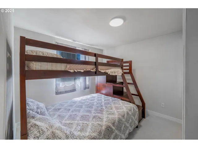 a bedroom with a bed and a night stand