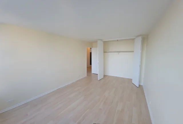 a view of an empty room and wooden floor