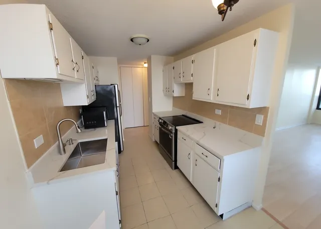 a view of a kitchen with electric appliances