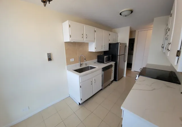 a kitchen with stainless steel appliances a refrigerator sink and cabinets